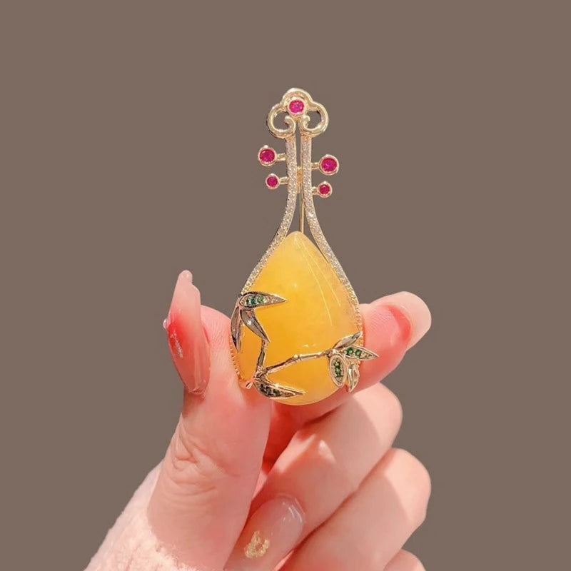 Yellow pipa brooch